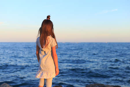 Young attractive girl near the ocean on a summer dayの写真素材