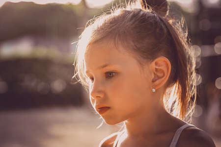 Small happy girl enjoys hot summer day. Beauty child outdoors enjoying nature.の写真素材