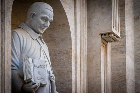 Beautiful sculpture of a man with a book on his handsのeditorial素材