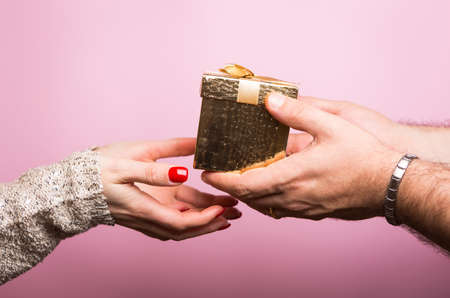 Hands giving and receiving a present