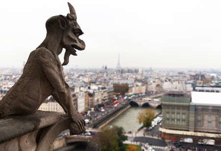 PARIS, FRANCE - NOVEMBER 29, 2013: Gargoyle of the Cathedral of Notre Dame de Paris overlooking Paris, Franceのeditorial素材