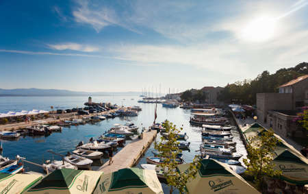 BOL,BRAC,CROATIA - AUGUST 3: Crowded beach of Zlatni Rat and village pier on August 03, 2014 in Bol, Croatia. Bol is one of the most famous tourist desinations on the adriatic islands.のeditorial素材