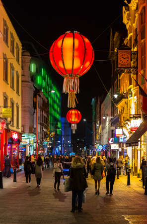 LONDON - OCTOBER 30 : People on a busy street in Chinatown, London on the night of October 30 2014. Chinatown is located in Soho with Chinese restaurants, supermarkets and gift shops.のeditorial素材