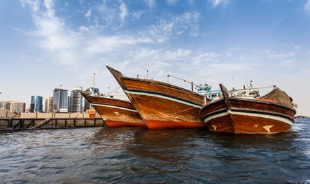 DUBAI, UAE-MAY17 2015: Dhows old wooden sailing vessels are docked along the Deira side of Dubai Creekのeditorial素材