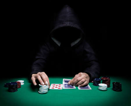 Unknown woman playing poker on green table with chips all around, front view