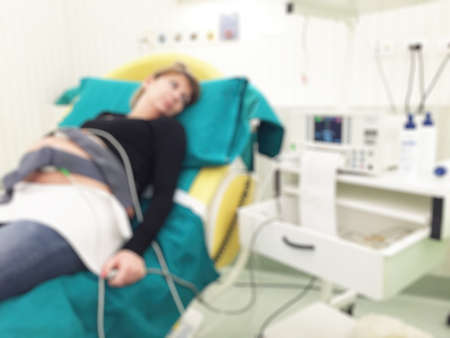 Blurred image of pregnant patient in hospital bed for background usage.の写真素材