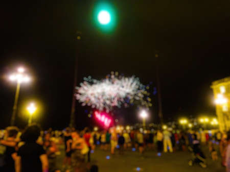 Blurred scene of people looking a with fireworksの写真素材