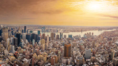 The New York City USA .Manhattan downtown and skyline skyscrapers at sunset with the Hudson river and Brooklyn bridge. Extreme Panoramaのeditorial素材