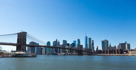 View of Brooklyn Bridge and Manhattan skyline WTC Freedom Tower from Dumbo, Brooklyn. Brooklyn Bridge is one of the oldest suspension bridges in the USAの写真素材