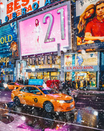 New York City, USA - March 18, 2017: People and famous led advertising panels in Times Square during the snow, one of the symbol of New York City.のeditorial素材