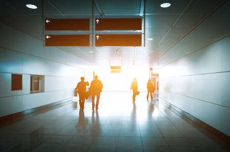 Silhouette of a unrecognizable business travelers people at international airport moving to terminal gate for airplane travel trip の写真素材