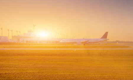 Airplane at the terminal gate ready for takeoff - Modern international airport during sunrise - Concept travel around the worldの写真素材