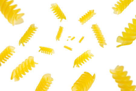Collection of Italian Pasta fusilli falling isolated on white background. Selective focusの写真素材