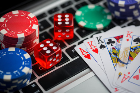 Computer Keyboard Covered With Playing Cards, chips and Dice.の素材
