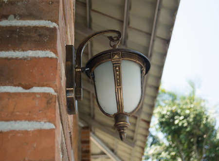 Side Angle View Of The Classic Modern Decorative Lamp Is Mounted On The Outdoor Brick Wallの写真素材