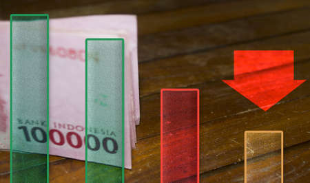 Indonesian Rupiah Currency With Graphic And Red Arrow Sign. Currency Exchange Concept