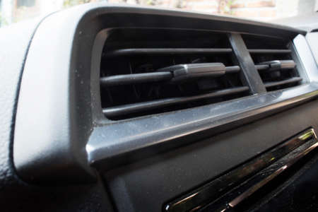 Several Holes Extending for air conditioning ventilation with a grille partition on the dashboard of...