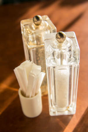salt and pepper on a wooden tableの写真素材