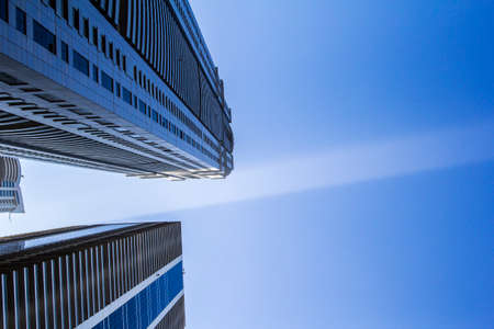 a ray of sunshine in the morning between skyscrapers in Dubai Marinaのeditorial素材