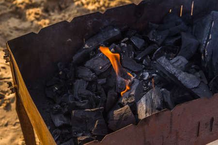 fire burning coals in the grill for barbecueの写真素材