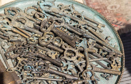 vintage background vintage brass keys on a large copper trayの写真素材