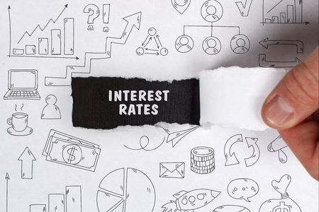 Business, Technology, Internet and network concept. Young businessman shows the word: Interest rates