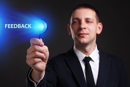 The concept of business, technology, the Internet and the network. A young entrepreneur working on a virtual screen of the future and sees the inscription: Feedbackの写真素材