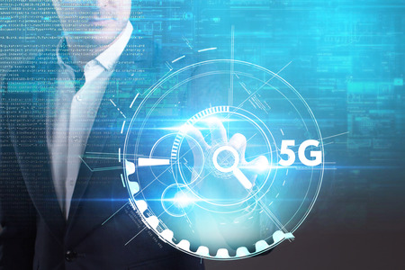 Business, Technology, Internet and network concept. Young businessman working on a virtual screen of the future and sees the inscription: 5Gの写真素材