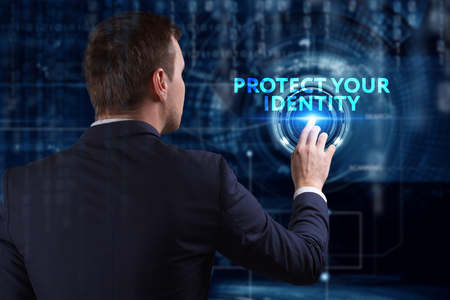 Business, Technology, Internet and network concept. Young businessman working on a virtual screen of the future and sees the inscription: Protect your identityの写真素材