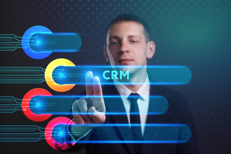Business, Technology, Internet and network concept. Young businessman working on a virtual screen of the future and sees the inscription: CRMの写真素材