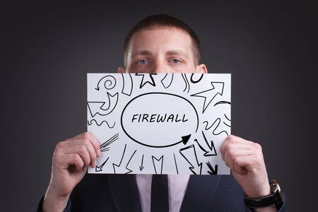 The concept of business, technology, the Internet and the network. Young businessman showing inscription: Firewallの写真素材