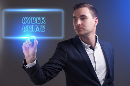 The concept of business, technology, the Internet and the network. Young businessman showing inscription: Cyber crimeの写真素材