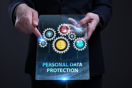 Business, Technology, Internet and network concept. Young businessman working on a virtual screen of the future and sees the inscription: Personal data protectionの写真素材