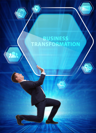 Business, Technology, Internet and network concept. Young businessman working on a virtual screen of the future and sees the inscription: Business transformationの写真素材