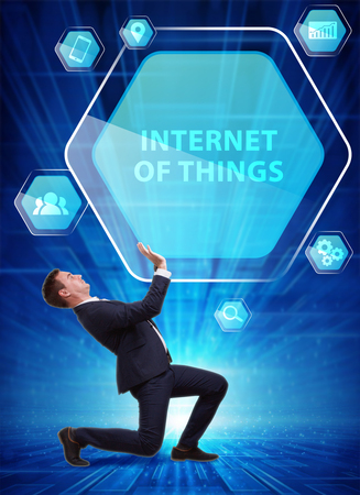 Business, Technology, Internet and network concept. Young businessman working on a virtual screen of the future and sees the inscription: Internet of thingsの写真素材