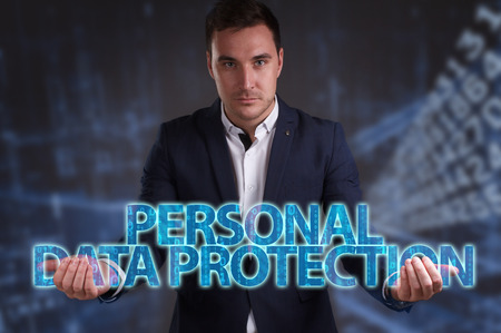 The concept of business, technology, the Internet and the network. Young businessman showing inscription: Personal data protectionの写真素材
