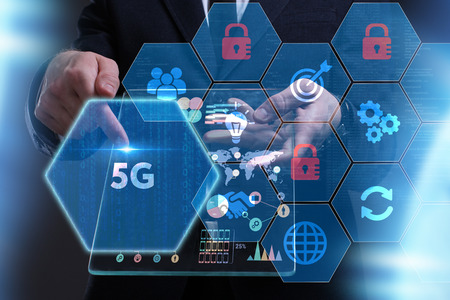 Business, Technology, Internet and network concept. Young businessman working on a virtual screen of the future and sees the inscription: 5Gの写真素材