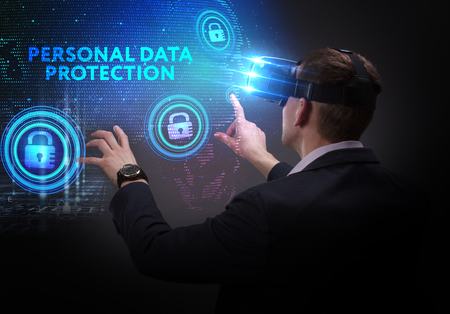 Business, Technology, Internet and network concept. Young businessman working on a virtual screen of the future and sees the inscription: Personal data protectionの写真素材