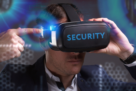 Business, Technology, Internet and network concept. Young businessman working in virtual reality glasses sees the inscription: Securityの写真素材