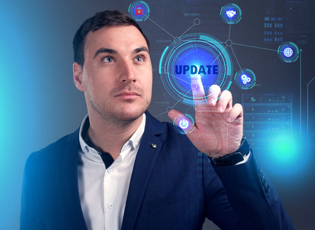 Business, Technology, Internet and network concept. Young businessman working on a virtual screen of the future and sees the inscription: Updateの写真素材