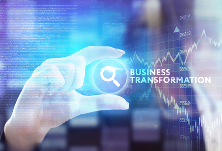 The concept of business, technology, the Internet and the network. A young entrepreneur working on a virtual screen of the future and sees the inscription: Business transformationの写真素材