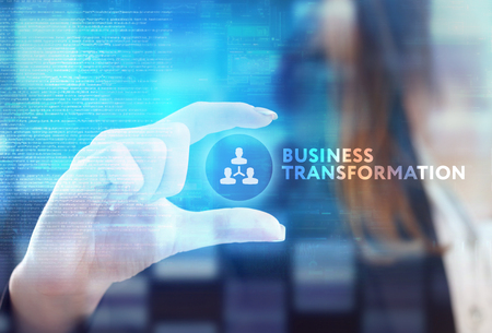 The concept of business, technology, the Internet and the network. A young entrepreneur working on a virtual screen of the future and sees the inscription: Business transformationの写真素材