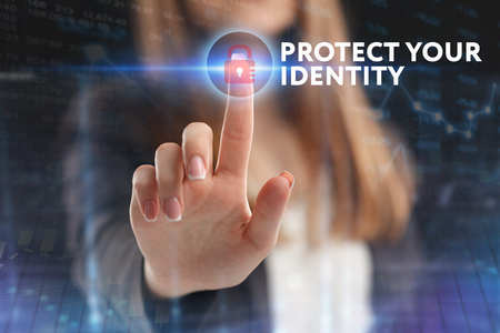 The concept of business, technology, the Internet and the network. A young entrepreneur working on a virtual screen of the future and sees the inscription: Protect your identityの写真素材