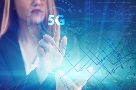 The concept of business, technology, the Internet and the network. A young entrepreneur working on a virtual screen of the future and sees the inscription: 5Gの写真素材