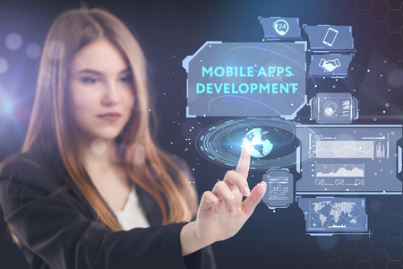 The concept of business, technology, the Internet and the network. A young entrepreneur working on a virtual screen of the future and sees the inscription: Mobile apps developmentの写真素材