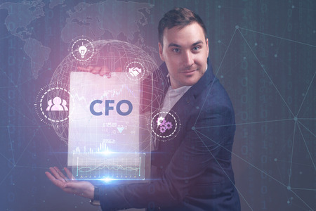 The concept of business, technology, the Internet and the network. A young entrepreneur working on a virtual screen of the future and sees the inscription: CFOの写真素材