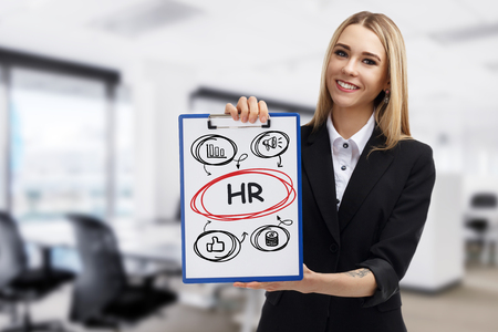 Business, technology, internet and networking concept. Young entrepreneur showing keyword: HRの写真素材