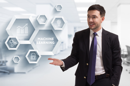 The concept of business, technology, the Internet and the network. A young entrepreneur working on a virtual screen of the future and sees the inscription: Machine learningの写真素材