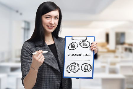 Business, technology, internet and networking concept. Young entrepreneur showing keyword: Remarketingの写真素材