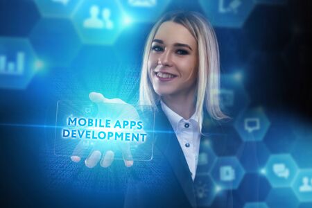 The concept of business, technology, the Internet and the network. A young entrepreneur working on a virtual screen of the future and sees the inscription: Mobile apps developmentの写真素材